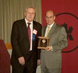 Chuck Moore presenting a Presidential Award to David Dingwall on behalf of the Royal Canadian Mint
