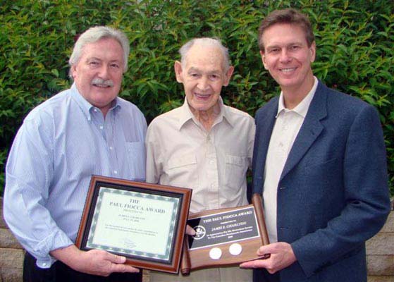 Charles Moore and Paul Winkler, Trajan Publishing Corporation, presenting James E. Charlton with the Paul Fiooca Award 
