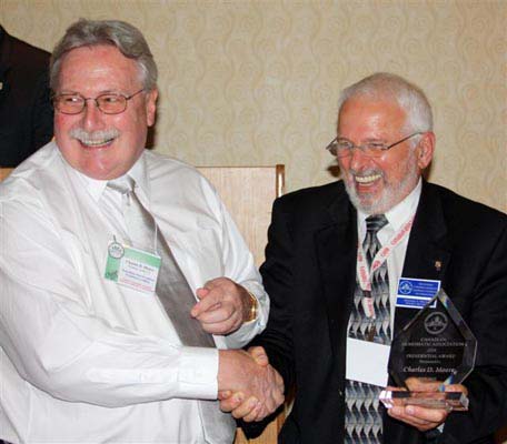 Charles Moore receiving a Presidential Award from Michael Walsh
