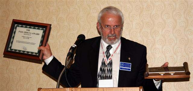 Michael Walsh announcing the Paul Fiooca Award recipient James E. Charlton