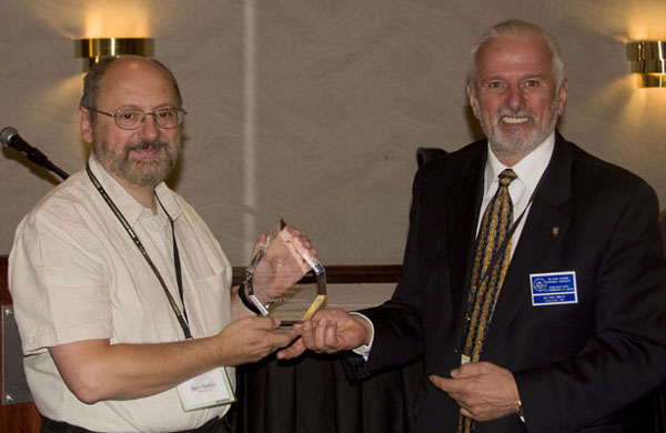 Henry Nienhuis receiving a Presidential Award from Michael Walsh, President of the RCNA 