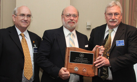 Tim Henderson (centre) accepting the Paul Fiooca Award from Dan Gosling (left) and Charles Moore (right)