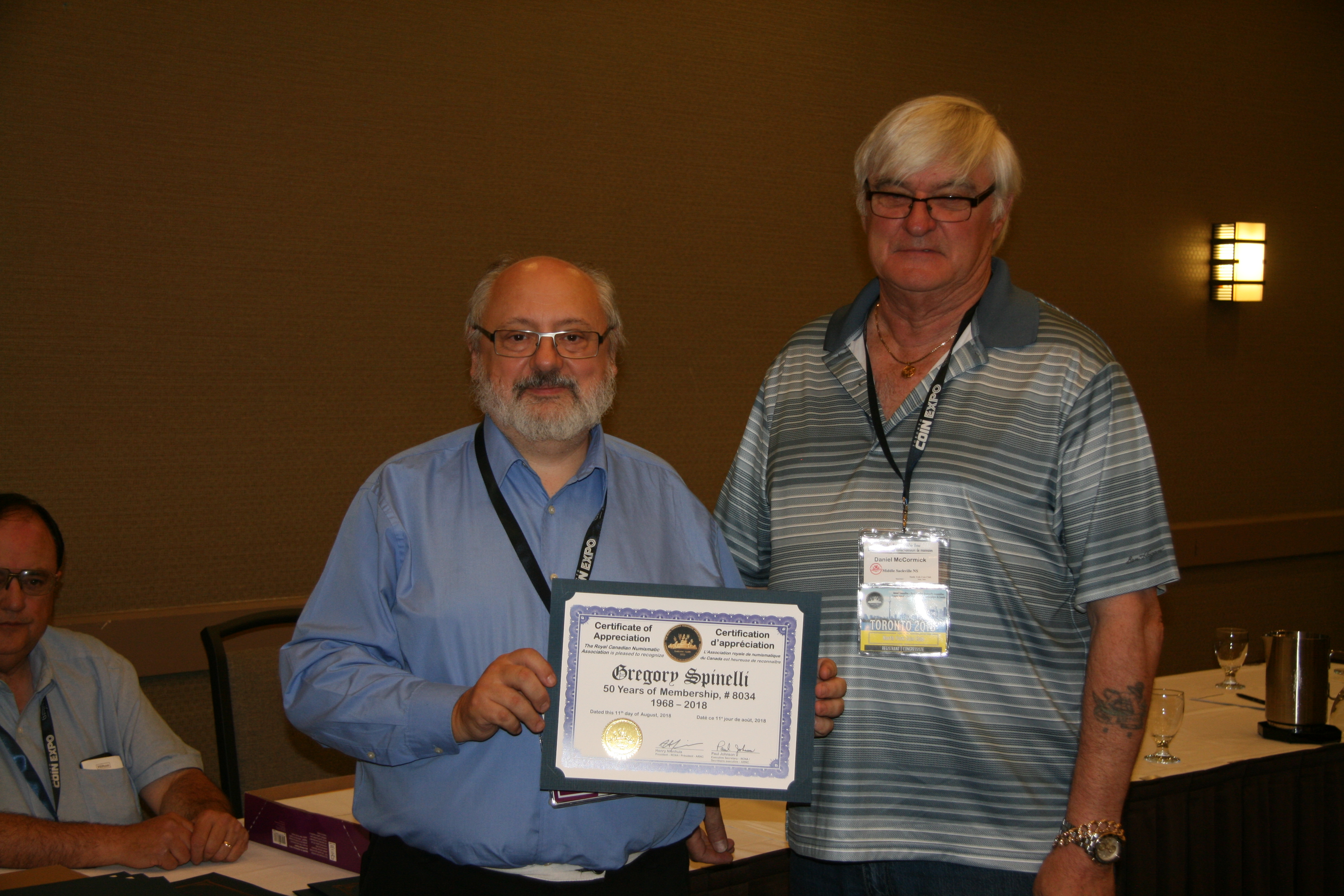 <p><strong>Dan McCormick</strong> (right) accepting the award for <strong>Gregory Spinelli</strong> who received his 50 years of membership recognition award from <strong>Henry Nienhuis</strong> (left).<br /> <small>Dan Gosling photo</small></p>